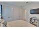Bright bedroom with neutral decor, double closet, and a mounted television at 11785 Little River Way, Parrish, FL 34219
