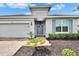 Stylish front door with a decorative initial, complemented by well-maintained landscaping at 11785 Little River Way, Parrish, FL 34219