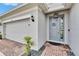Close up of modern front door and brick walkway with a decorative door knocker at 11785 Little River Way, Parrish, FL 34219