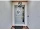 Stylish blue front door with modern hardware and a decorative 'S' emblem at 11785 Little River Way, Parrish, FL 34219