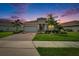 Attractive single-story home with a well-manicured lawn, mature landscaping, and a brick driveway at 11785 Little River Way, Parrish, FL 34219