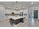 Stylish kitchen with white cabinets, stainless steel appliances, and a central island with seating at 11785 Little River Way, Parrish, FL 34219