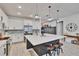 Contemporary kitchen with white cabinets, stainless steel appliances, and a center island with stools at 11785 Little River Way, Parrish, FL 34219