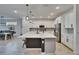 Modern kitchen boasting a large center island with pendant lights and stainless steel appliances at 11785 Little River Way, Parrish, FL 34219
