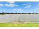 Scenic lake view showcasing the tranquil water and the surrounding neighborhood homes at 11785 Little River Way, Parrish, FL 34219