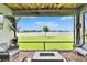 Relax on the lanai with a brick floor, a stained-wood ceiling, and peaceful lake views at 11785 Little River Way, Parrish, FL 34219