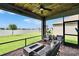Lanai with seating and firepit features serene views of the lake and backyard at 11785 Little River Way, Parrish, FL 34219