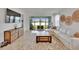 Bright living room with sliding glass doors, a view of the lake, and modern decor at 11785 Little River Way, Parrish, FL 34219