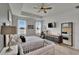 The main bedroom boasts water views and a ceiling fan for added comfort at 11785 Little River Way, Parrish, FL 34219