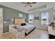 Bright bedroom with a lake view, tray ceiling, tiled floors, and a crib at 11785 Little River Way, Parrish, FL 34219