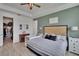 Bright main bedroom featuring a walk-in closet, ceiling fan, ensuite bath, and neutral colors at 11785 Little River Way, Parrish, FL 34219