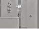 Bright shower featuring glass door, tiled walls, shower head and wall accessories at 11785 Little River Way, Parrish, FL 34219