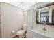 Cozy bathroom featuring a toilet, sink, mirror, and shower with a curtain at 11809 Raintree Lake Ln # A, Tampa, FL 33617