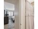 Bathroom featuring a toilet, sink, shower with a curtain, and a bedroom view at 11809 Raintree Lake Ln # A, Tampa, FL 33617