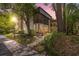 Charming condo featuring a screened lanai, mature trees, and lush landscaping in evening light at 11809 Raintree Lake Ln # A, Tampa, FL 33617