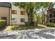 Condo exterior with mature trees and landscaping at 11809 Raintree Lake Ln # A, Tampa, FL 33617