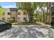Condo exterior with mature trees, landscaping, and convenient parking at 11809 Raintree Lake Ln # A, Tampa, FL 33617