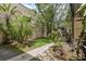 Manicured grounds with lush landscaping and a sidewalk leading to a building in the complex at 11809 Raintree Lake Ln # A, Tampa, FL 33617