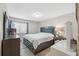 Well-lit main bedroom featuring a queen bed, carpet floors, and a window with blinds at 11809 Raintree Lake Ln # A, Tampa, FL 33617