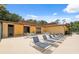 A pool area with lounge chairs and a bathhouse providing seating and relaxing space at 11809 Raintree Lake Ln # A, Tampa, FL 33617