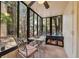 Cozy sunroom with tiled floor and views of the complex's landscaping from the surrounding windows at 11809 Raintree Lake Ln # A, Tampa, FL 33617