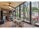 Bright sunroom with a ceiling fan, tile flooring, and views of the well-maintained landscaped grounds at 11809 Raintree Lake Ln # A, Tampa, FL 33617