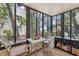 Inviting sunroom with lots of light, tiled floor, and tranquil views of the community landscape at 11809 Raintree Lake Ln # A, Tampa, FL 33617