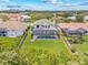 Aerial view of the home with screened pool and patio, fenced yard, and neighborhood with Downtown St Pete in the distance at 1191 Darlington Oak Ne Dr, St Petersburg, FL 33703