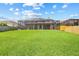 Spacious backyard with lush green grass and privacy fence at 1191 Darlington Oak Ne Dr, St Petersburg, FL 33703