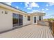 A house has a balcony with wood decking, and black railings at 1191 Darlington Oak Ne Dr, St Petersburg, FL 33703