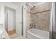 Bathroom featuring a tiled shower over tub and white door leading to another room at 1191 Darlington Oak Ne Dr, St Petersburg, FL 33703