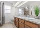 Bright bathroom featuring a double vanity with granite countertop and tiled floors at 1191 Darlington Oak Ne Dr, St Petersburg, FL 33703