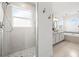 Bright bathroom features a glass enclosed shower, soaking tub, and double vanity at 1191 Darlington Oak Ne Dr, St Petersburg, FL 33703