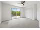 A bedroom boasts a balcony and a ceiling fan at 1191 Darlington Oak Ne Dr, St Petersburg, FL 33703