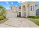 Attractive two-story home featuring an attached garage and meticulously maintained landscaping at 1191 Darlington Oak Ne Dr, St Petersburg, FL 33703