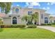 Beautiful two-story home with a well-manicured lawn, lush landscaping, and a neutral color scheme at 1191 Darlington Oak Ne Dr, St Petersburg, FL 33703