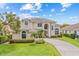 Two-story home featuring an attached garage, well-manicured lawn, and lush landscaping at 1191 Darlington Oak Ne Dr, St Petersburg, FL 33703