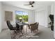 Home office features modern desk, sliding glass door, and ample natural light at 1191 Darlington Oak Ne Dr, St Petersburg, FL 33703