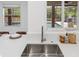Kitchen with counter and sink under a window with views to the outdoor pool and greenery at 1191 Darlington Oak Ne Dr, St Petersburg, FL 33703