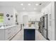 Bright kitchen features white cabinets, stainless steel appliances, and a contrasting island at 1191 Darlington Oak Ne Dr, St Petersburg, FL 33703