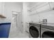 A well-organized laundry room features modern washer/dryer and storage at 1191 Darlington Oak Ne Dr, St Petersburg, FL 33703