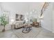 Sunlit living room featuring a soaring ceiling, elegant windows, and contemporary décor at 1191 Darlington Oak Ne Dr, St Petersburg, FL 33703