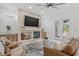 Bright living room with fireplace, ceiling fan, and view of the backyard at 1191 Darlington Oak Ne Dr, St Petersburg, FL 33703