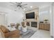 Cozy living room featuring a stone fireplace, contemporary furniture, and natural light at 1191 Darlington Oak Ne Dr, St Petersburg, FL 33703