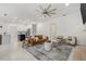 Open-concept living room with kitchen, modern furnishings, and expansive ceiling fan at 1191 Darlington Oak Ne Dr, St Petersburg, FL 33703