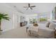 Spacious main bedroom with a ceiling fan, sitting area, and en-suite bathroom is brightly lit at 1191 Darlington Oak Ne Dr, St Petersburg, FL 33703