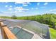 Aerial view of the screened-in pool and spa area overlooking a lush green landscape at 1191 Darlington Oak Ne Dr, St Petersburg, FL 33703