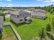 Aerial view of a gray two-story house with solar panels in a residential neighborhood at 12481 Aston Dr, Hudson, FL 34669