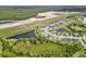 High-angle view of a residential development with lakes, juxtaposed against a construction zone and power lines at 12481 Aston Dr, Hudson, FL 34669