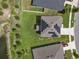 Birds-eye view of the house with solar panels, manicured lawn and backyard, in a residential neighborhood at 12481 Aston Dr, Hudson, FL 34669